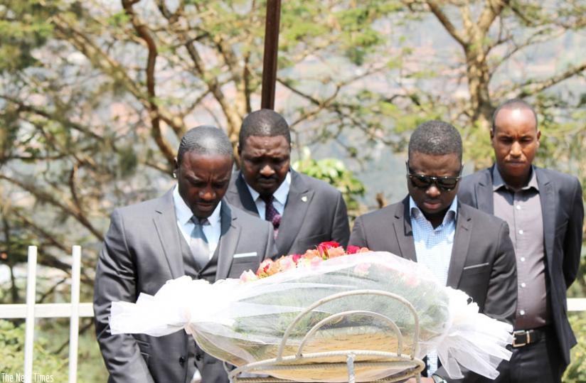 Akon (L), Bathily (C) and Niang (R) pay respects after laying a wreath at the Kigali Genocide Memeorial Centre. (Moses Opobo)