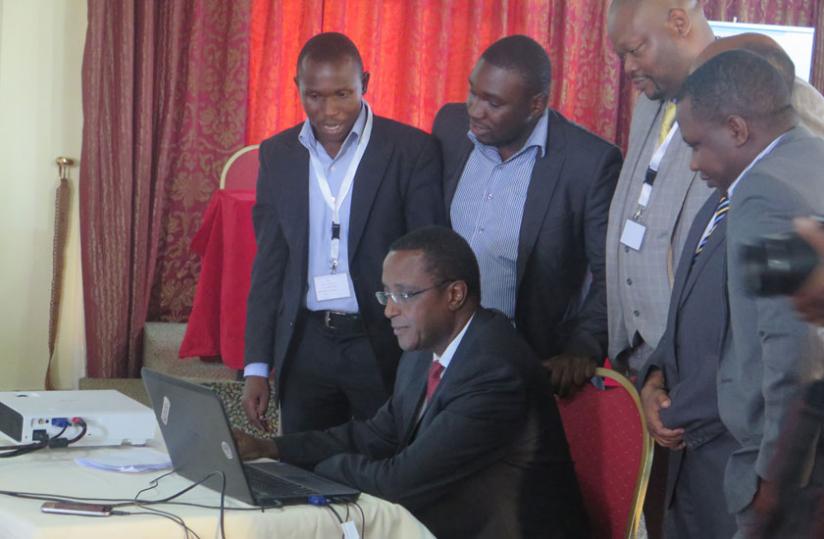 Biruta logs in to Rwanda geoportal web site during the launch yesterday. (Theogene Nsengimana)