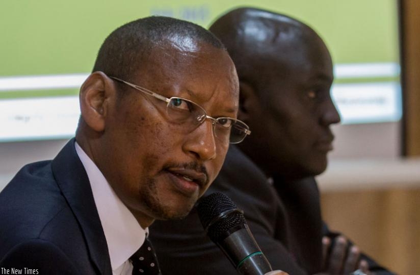 Central bank Governor John Rwangombwa (L) speaks at the closure of BNR's research conference in Kigali yesterday as National Bank of Rwanda chief economist Thomas Kigabo looks on. (Timothy Kisambira)