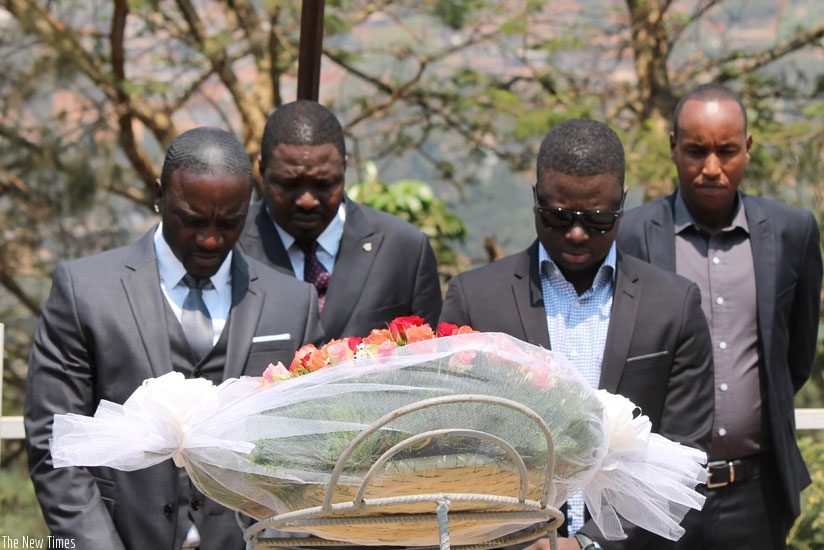 Akon (left) and business partners, Samba Bathily (C) and Thione Niang (R) pay respects after laying a wreath at the Kigali Memorial Center (Moses Opobo)
