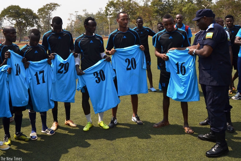 IGP Emmanuel K. Gasana (R) unveils the new signings for Police FC at Kicukiro Stadium. (Courtesy)