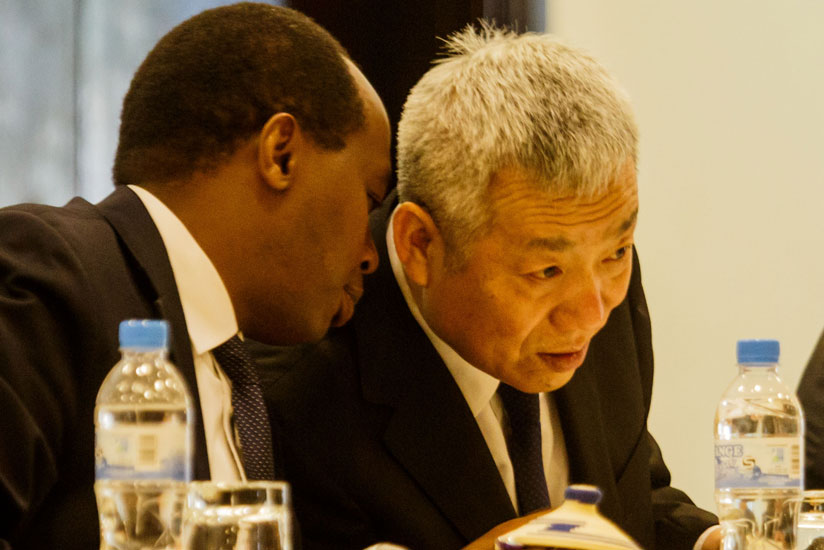 RDB chief executive Francis Gatare chats with the Chinese Ambassador to Rwanda, Shen Yongxiang, during the East Africa-China Business Forum in Kigali yesterday.rn(All photos by Timothy Kisambira)
