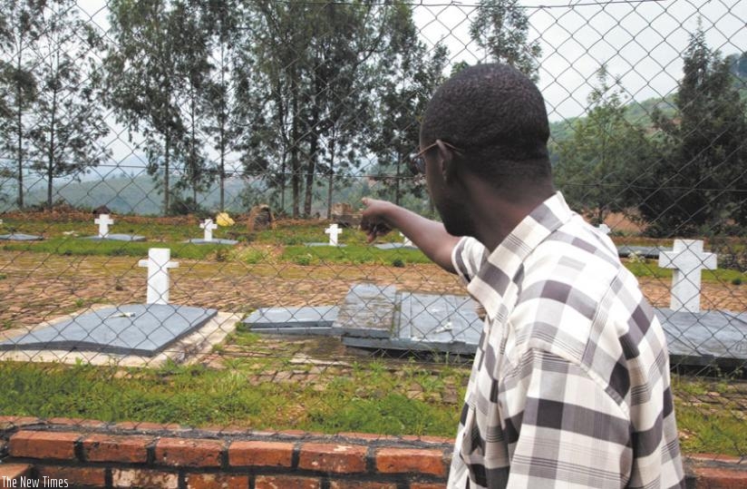A Genocide survivor points at a spot where he suspects that his family members were buried at a church in Nyange. (T. Kisambira)
