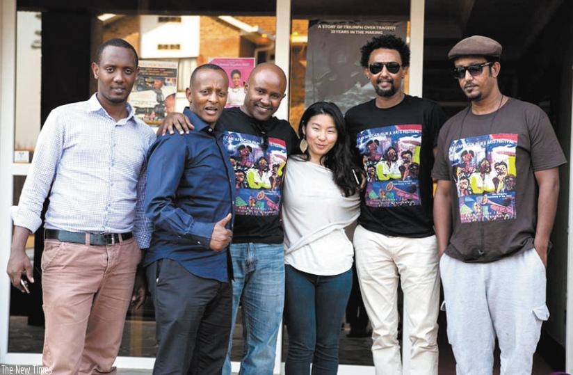 The stars of the opening night film 'Triange Solomon Bogale' and its director Theodros Teshome (3rd L) and Kabera pose for a photo after a workshop. 