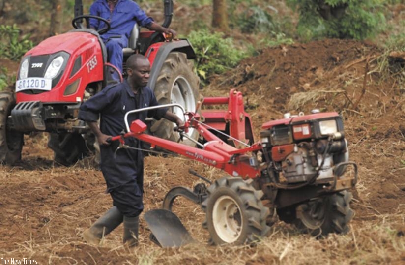 A farmer uses a hand-held plough to cultivate his land. Agriculture mechanisation is essential to increase the countryu2019s agricultural production. (Peterson Tumwebaze)