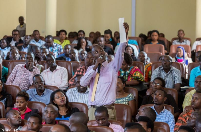 A researcher from University of Rwanda's College of Education displays a document that contains reasons why Article 101 should be amended. (Timothy Kisambira)