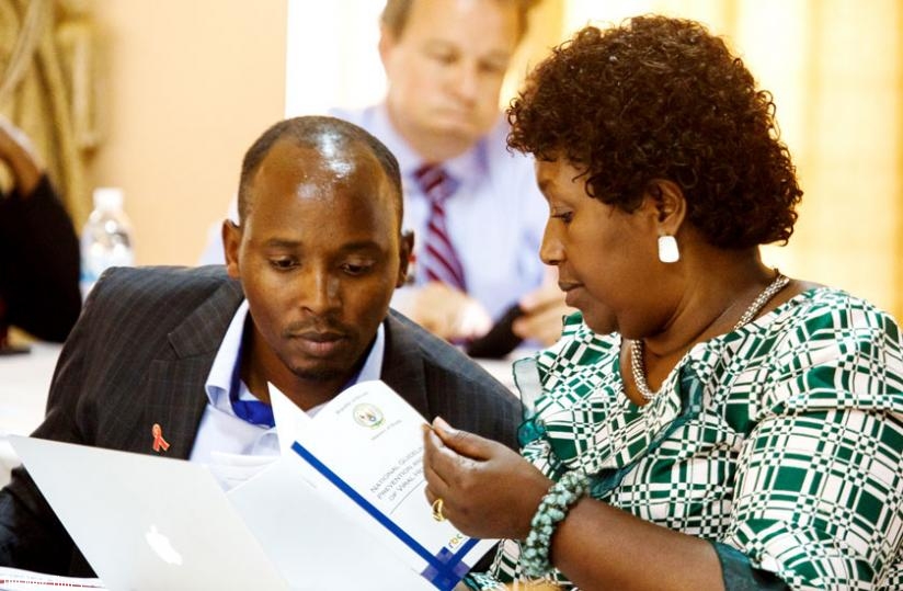 Dr Sabin Nsanzimana, the head of HIV/Aids division at Rwanda Biomedical Centre (L), goes through a document with Health minister Dr Agnes Binagwaho. (Timothy Kisambira)