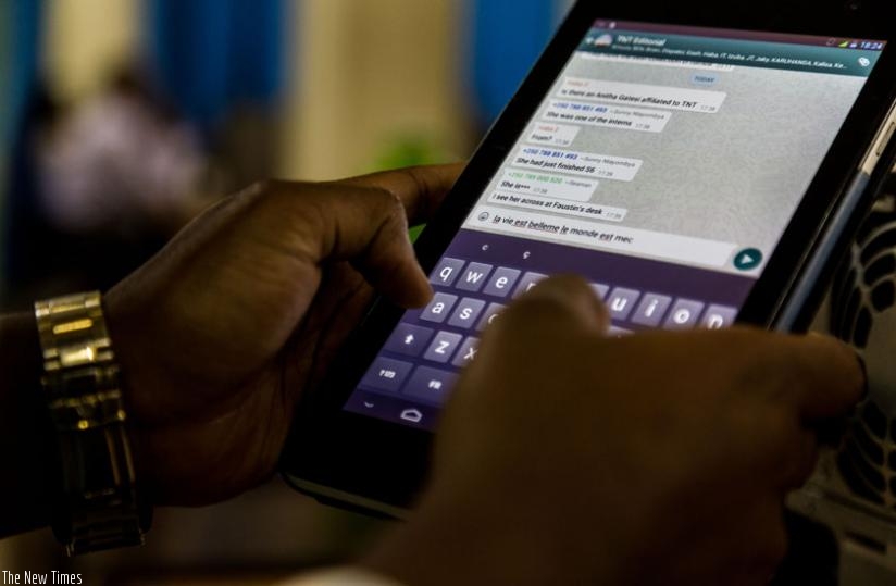 A mobile phone user sends an SMS. Tigo and MTN Rwanda have already revised the SMS charges, while Airtel Rwanda is also in the process to implement the second phase of the Norther Corridor One Network Area initiative. (Timothy Kisambira)