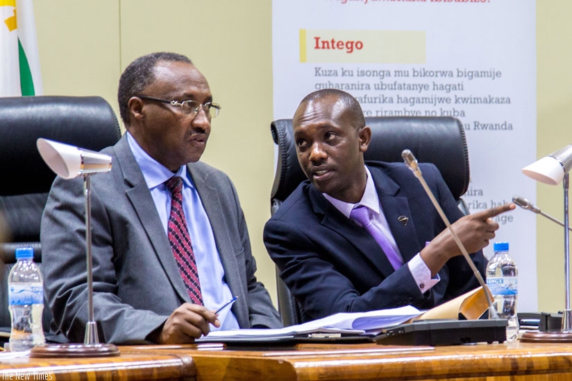 Protais Musoni (L) and Cyrus Munyaburanga Nkusi briefly chat after being elected to represent Rwanda in the Pan African Movement. (Doreen Umutesi)