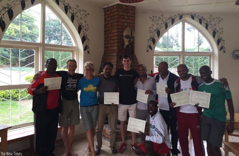 African cycling physiotherapists pose for a photo with Team Rwanda Cycling head coach Jonathan Boyer (2nd left), Coats (3rd left) and Golden (center) on Thursday at the Africa Rising Cycling Center in Musanze. (Courtesy)