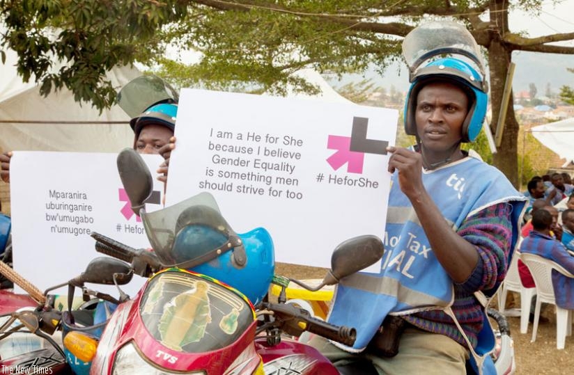 Motorcyclists display messages showing their commitment to support gender equality. (Faustin Niyigena)