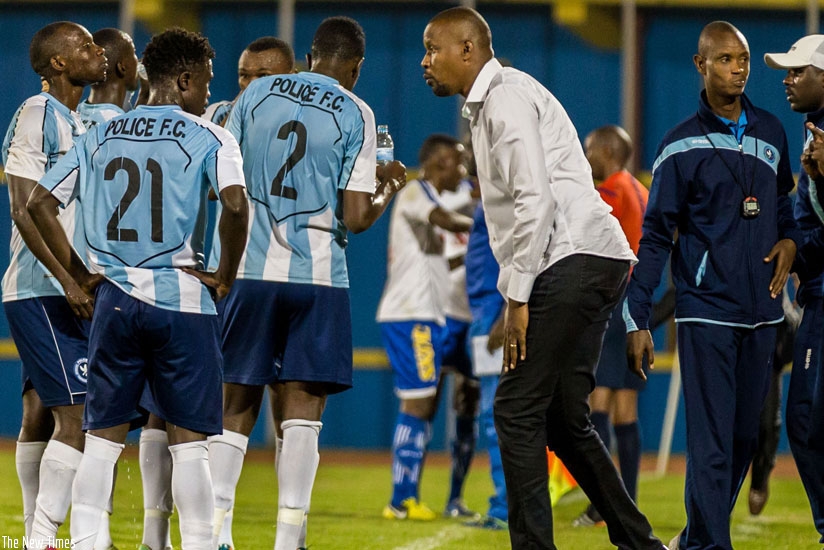 Police FC head coach Andre Cassa Mbungo (in white shirt) talks to his players during the Peace Cup final in July. (Timothy Kisambira)