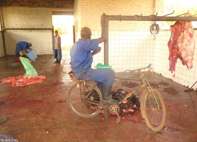 Butchers prepare meat on the floor inside Nyarusange Abattoir. (Stephen Rwembeho)