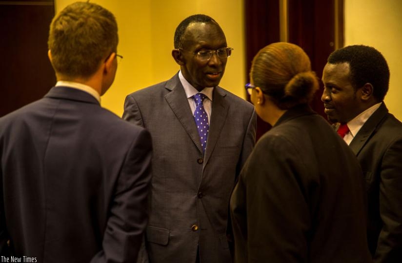 Rugege (C) chats with William Gelling (L), the British High Commissioner to Rwanda; Sibongile Dludlu, the UNAIDS' country director; and Tom Mulisa (R), the executive director of GLIHD at the symposium. (Doreen Umutesi)