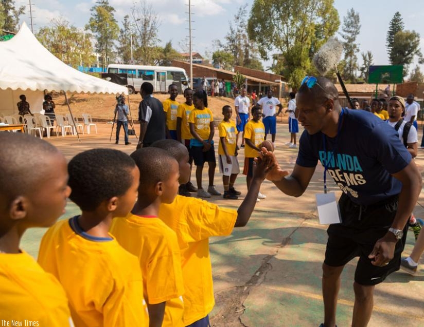 HI-FIVE: Toronto Raptors' general manager Masai Ujiri interacts with the young players at Rafiki Community Centre yesterday. (Timothy Kisambira)
