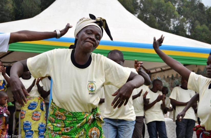 A wife of one of former FDLR combatants dances at the discharge ceremony in Musanze. (Jean D. MBonyinshuti)