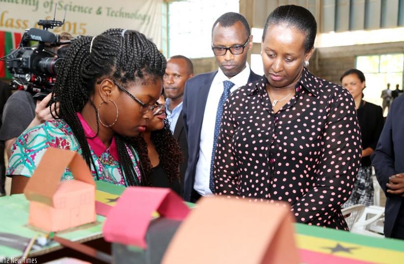 First Lady Jeannette Kagame and Education minister Papias Musafiri listen to girls explain technology projects at the closure of a three-week 'Women in Science and Innovation' summer camp at Gashora Girls' Academy in Bugesera District yesterday. (Courtesy)