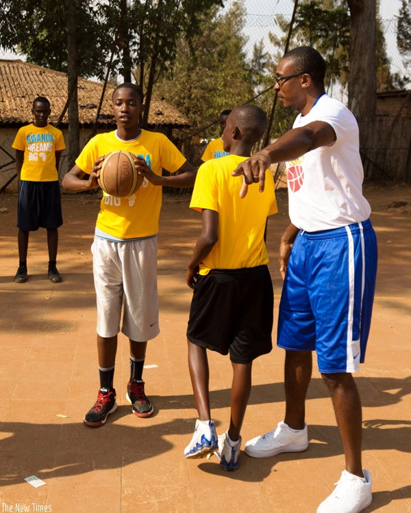 Denver Nuggets assistant coach Patrick Mutombo takes youngsters through some basketball drills. (Timothy Kisambira)