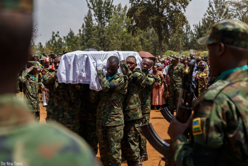 Rwanda Defence Force soldiers carry caskets of the fallen UN peacekeepers to the graves. (Timothy Kisambira)