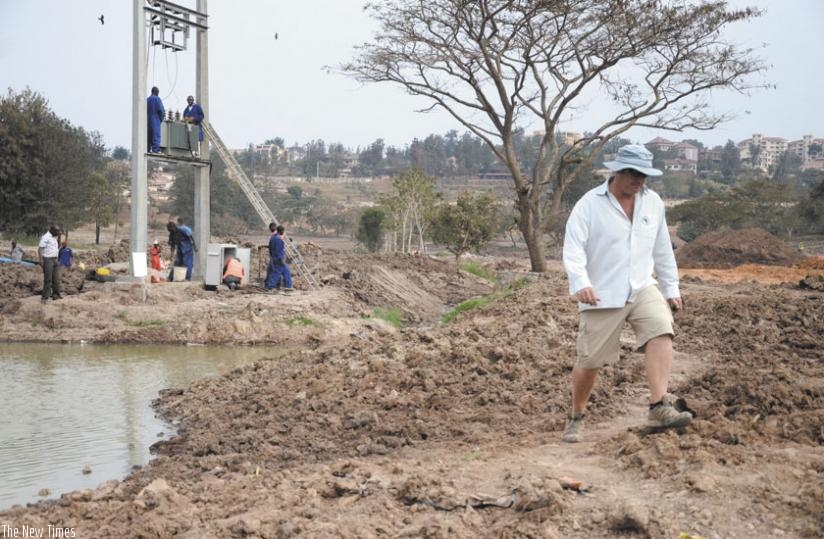 The project Designer and Supervisor, Darran Johnson (R), shows Times Sport around the Kigali Golf Club course which is undergoing redevelpment. (S. Ngendahimana)