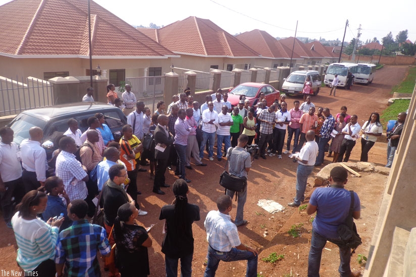 Potential home buyers tour the Rubirizi Homes estate (in the background) in Kabeza, Kanombe Sector during the KCB Property Bus Tour last year. The homes range from Rwf48 million to Rwf63 million, meaning they are out of reach of many Rwandans. (File)
