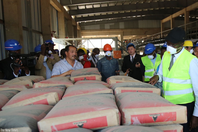 Murekezi (R) on a guided tour of  the new cimerwa cement plant yesterday. (Timothy Kisambira)