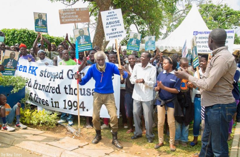 Protesters hold signs during a demonstration outside the British High Commission in Kigali call for the release of Gen. Karenzi Karake in June. (File)