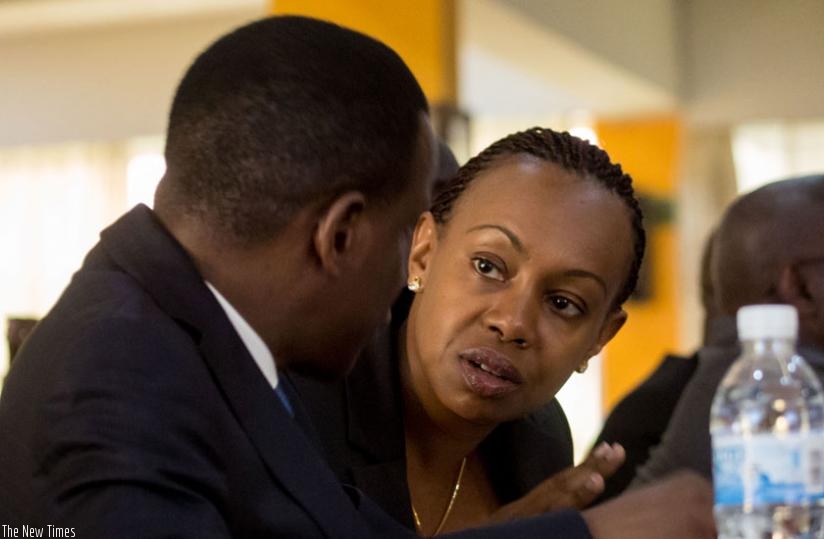 Antonio Pedro, UNECA's Director for the Eastern Region (L), chats with RDB's chief tourism officer Yamina Karitanyi at yesterday's meeting in Kigali. (Timothy Kisambira)