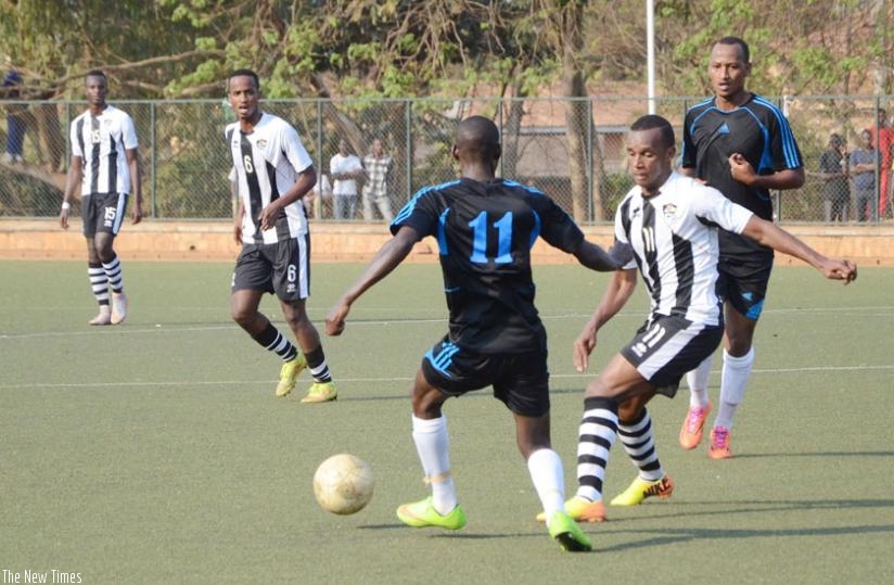 Patrick Sibomana (C) scored for APR in normal time as Police's Hegman Ngomirakiza (R) faced his  former team for the first time. (S. Ngendahimana)