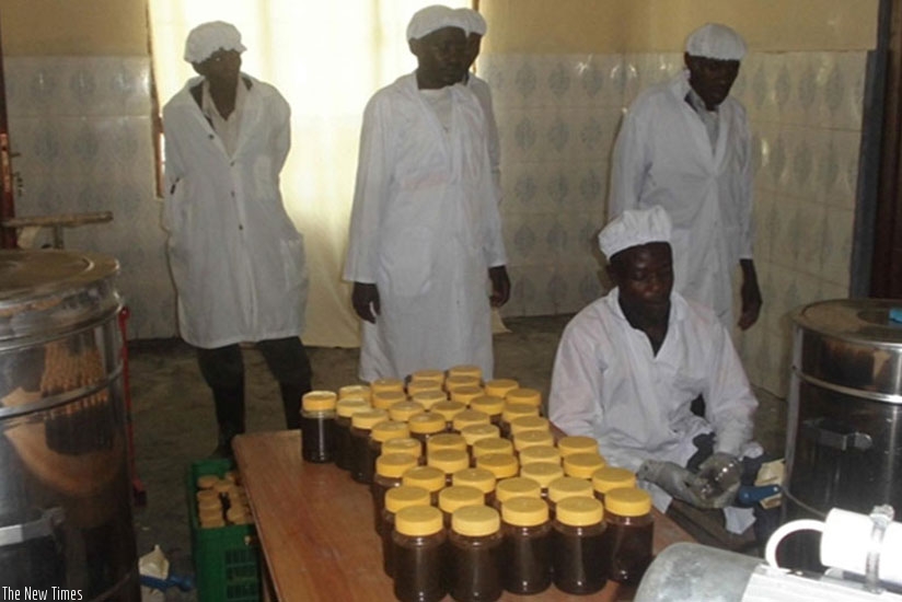 Honey being packaged after extraction in Huye District. (File)