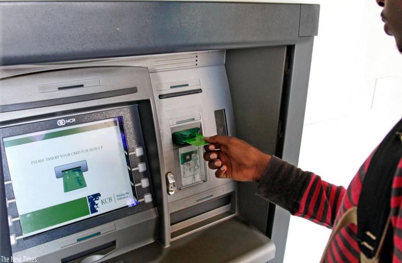 A client withdraws money from an ATM. Financial accounts' ownership among Rwanda's adult population of 7 million people stands at 77 per cent, according to the scorecard. (Timothy Kisambira)