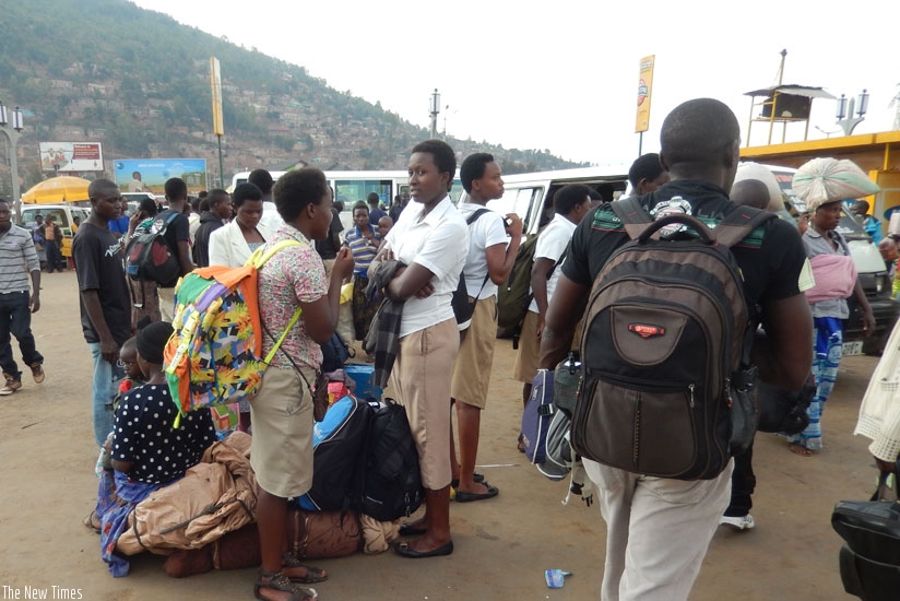 Students wait for a taxi in Nyabugogo park to return to school. Some students are sent back home as soon as they report to school over fees.  (Solomon Asaba)
