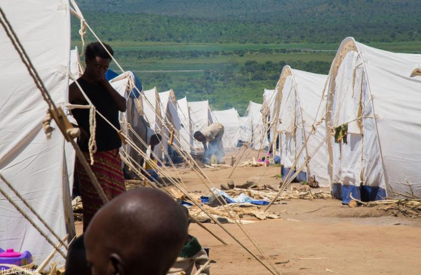 Burundian refugees prepare a meal at Mahama Camp. (Timothy Kisambira)