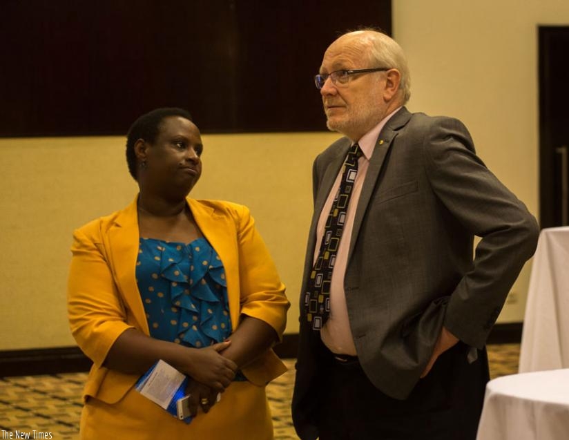 Dr Usta Kayitesi, the principal of the University of Rwanda's College of Arts and Social Sciences (L), chats with Prof James McWha, the vice-chancellor of the University of Rwanda. (Timothy Kisambira)