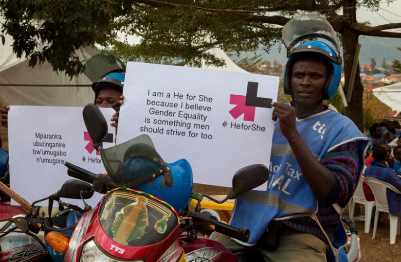 Motorcyclists display messages showing their commitment to support gender equality. (Faustin Niyigena)