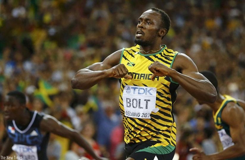 The world champion celebrates his victory at Beijing's Bird's Nest stadium by beating his clenched fists against his Jamaica vest. (Net photo)