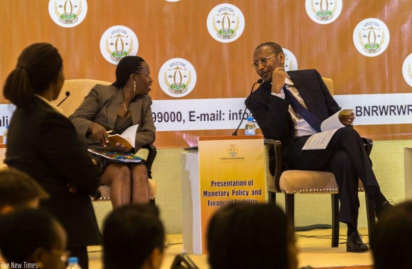 Central bank Governor John Rwangombwa (R) chats with his vice Dr Monique Nsanzabaganwa at the presentation of the monetary policy and financial stability statement in Kigali yesterday. (Timothy Kisambira)