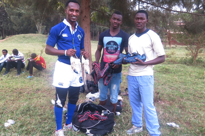 Jimmy Adams Mugabo (L) with Thousand Hills players at Centre des Jeunes. (S.Kalimba)