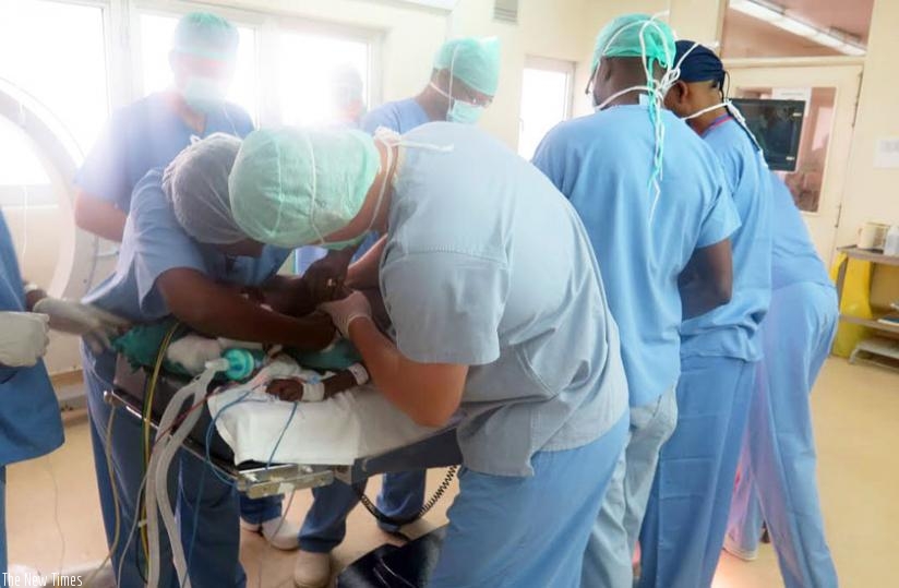 Medics during the surgery. Congenital scoliosis occurs in 1 out of 10,000 newborns.