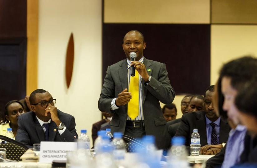 Morris Toroitich, the managing-director of KCB Rwanda and chairman Bankers Association,  reacts to a question on interest rates at the reading of the monetary policy and financial stability statement in Kigali on Thursday. (Timothy Kisambira)