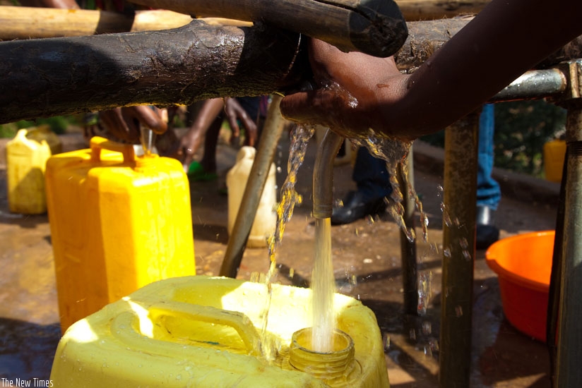 People draw water in Karongi District. (File)