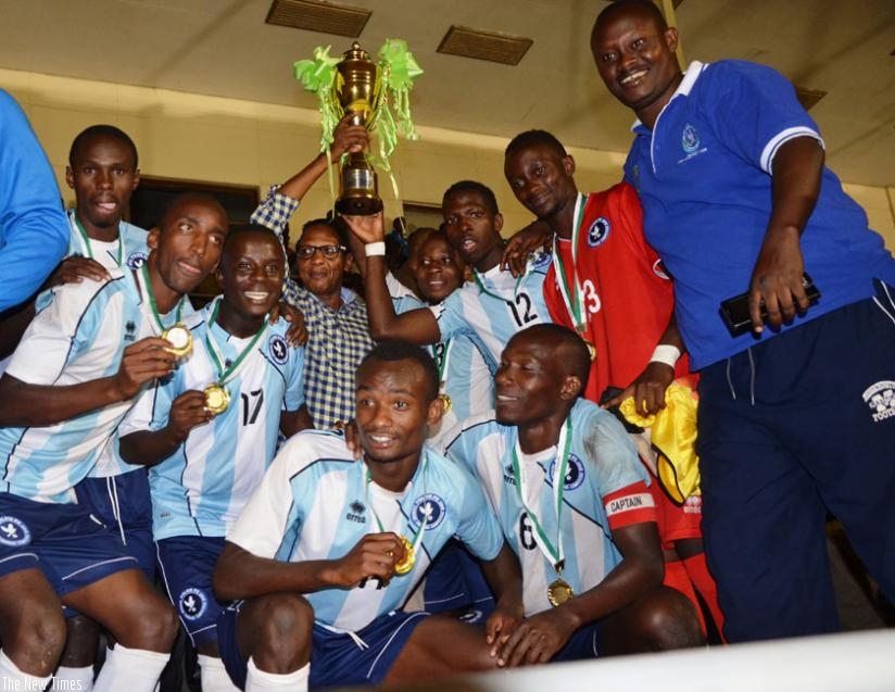Police FC president Col. (rtd) Dodo Twahirwa (C) leads his players in celebrating the Agaciro Cup yesterday at Amahoro stadium. rn(S. Ngendahimana)