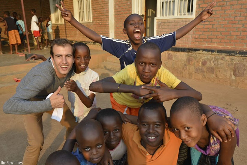 Olivier Demets (left) with some of the children at the Root Foundation. (Stephen Kalimba)