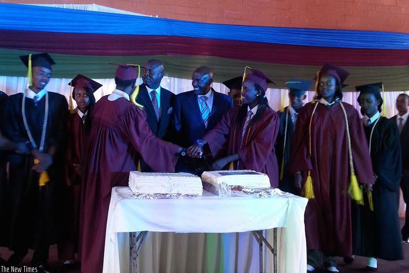 Kabonero (centre) and Onyango (second left) share a light moment with the graduands on Saturday. (Shamim Nire)