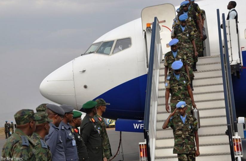 RDF Air Force personnel upon arrival home at Kigali International Airport (L) as another batch departs for Mission. (Courtesy)