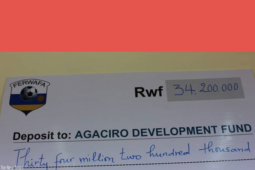 The dummy cheque for the FERWAFA contribution. (Courtesy)