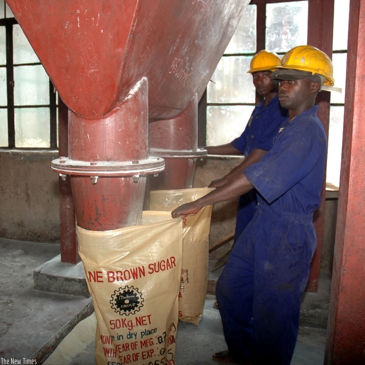 Workers at Kabuye Sugar Factory package sugar. A recent deal allowing Ugandan surplus sugar to access the Kenyan market has sparked off a row in the two EAC nations. (File)