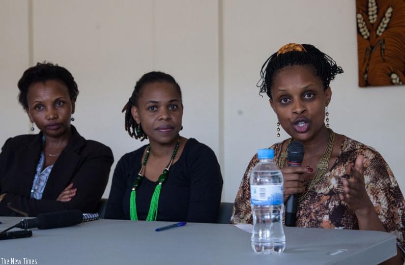 Pastor Mugisha (R) speaks during a press conference as Chikanya (C) and her assistant Regina Mukansanga look on. (Faustin Niyigena)