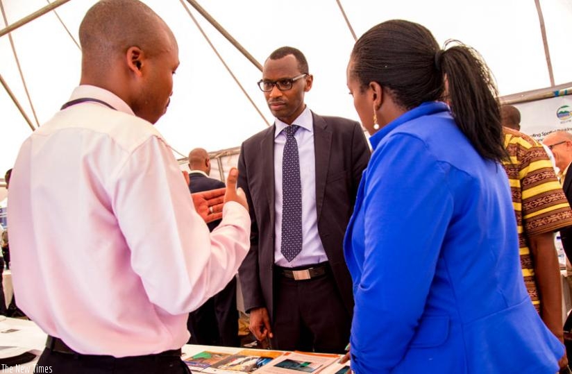 Minister Musafiri (centre) inspects a stall at the innovation for education exhibition yesterday at UR's College of Science and Technology. (Doreen Umutesi)