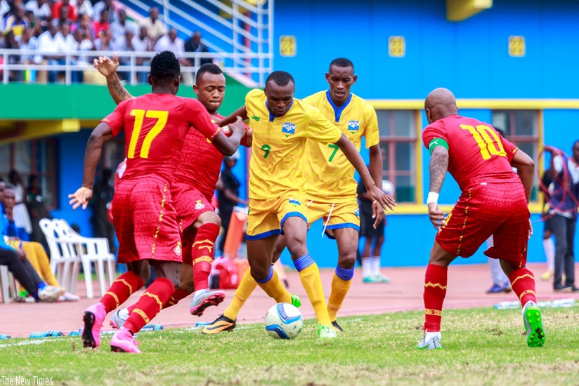 Rwanda's forward Jacques Tuyisenge (C) dribbles past Jordan Ayew, as Baba Rahman (L) and  Andre Ayew Morgan look on during yesterday's AFCON qualifier at Amahoro National Stadium. (Timothy Kisambira)